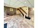 Lobby featuring tile flooring, staircase, brick accent wall with seating, and recessed lighting at 36750 Us 19 N Hwy # 3104, Palm Harbor, FL 34684