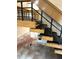 Staircase with wood and carpeted steps, complemented by a modern black metal railing design at 36750 Us 19 N Hwy # 3104, Palm Harbor, FL 34684