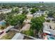 Aerial view of a home site with mature trees in a neighborhood setting with access to a nearby street at 3915 W Leila Ave, Tampa, FL 33616