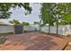 Backyard featuring a wooden deck, a shed, mature trees and fenced perimeter at 3915 W Leila Ave, Tampa, FL 33616