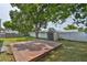 Spacious backyard featuring a wooden deck, shed, established trees and fenced yard at 3915 W Leila Ave, Tampa, FL 33616