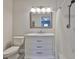 Bathroom with white vanity, marble countertop, and tiled shower with glass door at 3915 W Leila Ave, Tampa, FL 33616