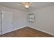 Bright bedroom featuring hardwood floors, ceiling fan, and natural light from a window at 3915 W Leila Ave, Tampa, FL 33616