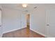 Bedroom with hardwood floors, a white door, and light streaming in through a window at 3915 W Leila Ave, Tampa, FL 33616