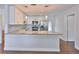 Bright kitchen featuring white cabinets, granite countertops, stainless steel appliances, and modern pendant lighting at 3915 W Leila Ave, Tampa, FL 33616