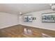 Inviting living room featuring wood-look flooring, neutral walls, and large windows that provide ample natural light at 3915 W Leila Ave, Tampa, FL 33616