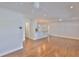 Spacious living area featuring wood-look flooring, ceiling fans, and an open layout leading to other areas of the home at 3915 W Leila Ave, Tampa, FL 33616