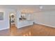 Well-lit living space with wood-look flooring, an open layout, and convenient access to the kitchen and laundry area at 3915 W Leila Ave, Tampa, FL 33616