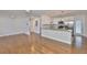 Open-concept living space featuring wood-look flooring, recessed lighting, and a seamless transition to the adjacent kitchen at 3915 W Leila Ave, Tampa, FL 33616