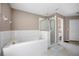 Spacious bathroom features a soaking tub, glass shower, and neutral color palette at 4222 Trumpworth Ct, Valrico, FL 33596