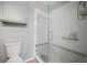 Modern bathroom features a glass-enclosed shower with white tile and gray accents at 4222 Trumpworth Ct, Valrico, FL 33596