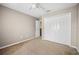 Neutral carpeted bedroom featuring a closet and a ceiling fan at 4222 Trumpworth Ct, Valrico, FL 33596