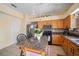Efficient kitchen featuring wood cabinets, granite countertops, stainless appliances, and a functional island for casual dining at 4222 Trumpworth Ct, Valrico, FL 33596