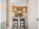 A home wet bar with overhead cabinets, granite countertop and easy kitchen access at 4222 Trumpworth Ct, Valrico, FL 33596
