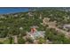 Aerial view of the property showcasing its location, surrounding trees, and proximity to the water at 509 Buckingham E Ave, Oldsmar, FL 34677