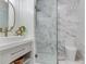 Modern bathroom featuring a glass-enclosed shower with elegant marble tiling and a stylish vanity at 509 Buckingham E Ave, Oldsmar, FL 34677