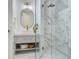 Modern bathroom showcasing a glass shower with marble accents, a sleek vanity, and stylish fixtures at 509 Buckingham E Ave, Oldsmar, FL 34677