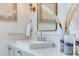 Stylish bathroom vanity with elegant faucet, candle decor, and marble countertops, creating a modern aesthetic at 509 Buckingham E Ave, Oldsmar, FL 34677