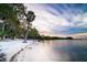 Scenic beach view featuring fine sand, clear water, and a peaceful sky with scattered clouds at 509 Buckingham E Ave, Oldsmar, FL 34677