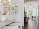 Elegant dining room with built-in display cabinets and a view into a bright office space, creating a harmonious flow at 509 Buckingham E Ave, Oldsmar, FL 34677
