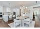 Open-concept kitchen and dining area with stylish pendant lighting and modern furnishings, perfect for entertaining and Gathering gatherings at 509 Buckingham E Ave, Oldsmar, FL 34677