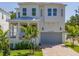 Beautiful two-story home featuring white siding, a covered porch, and a two-car garage at 509 Buckingham E Ave, Oldsmar, FL 34677