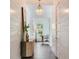 Bright hallway with hardwood floors, shiplap accent wall and natural light, featuring stylish decor at 509 Buckingham E Ave, Oldsmar, FL 34677