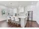 Bright kitchen with island seating, pendant lights, and modern stainless steel appliances at 509 Buckingham E Ave, Oldsmar, FL 34677
