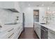 Modern kitchen with white marble countertops, stainless steel appliances, and custom cabinets, ideal for culinary enthusiasts at 509 Buckingham E Ave, Oldsmar, FL 34677