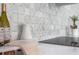 Close-up of kitchen backsplash featuring decorative tiles and sleek countertops, adding a touch of sophistication to the cooking space at 509 Buckingham E Ave, Oldsmar, FL 34677