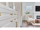 Bright living room with elegant white cabinets and gold hardware, complemented by hardwood floors and a cozy seating area at 509 Buckingham E Ave, Oldsmar, FL 34677