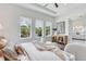 Bright main bedroom featuring three windows overlooking the verdant landscape with ensuite bathroom at 509 Buckingham E Ave, Oldsmar, FL 34677