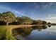 Scenic pond reflecting trees and sky on a clear day at 509 Buckingham E Ave, Oldsmar, FL 34677