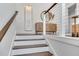 Stairway features hardwood treads, white risers, modern railing, and neutral decor at 509 Buckingham E Ave, Oldsmar, FL 34677