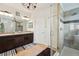 This bathroom features a granite double vanity and a tiled glass shower at 513 Harbor Springs Dr, Palm Harbor, FL 34683