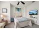 Brightly lit bedroom features a wooden headboard, ceiling fan, and mounted TV, enhancing its appeal at 513 Harbor Springs Dr, Palm Harbor, FL 34683