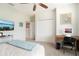 Light filled bedroom shows a view of a double closet, computer desk and ceiling fan at 513 Harbor Springs Dr, Palm Harbor, FL 34683
