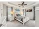 Serene bedroom features a tray ceiling, coastal decor, neutral tones, and two windows with privacy blinds at 513 Harbor Springs Dr, Palm Harbor, FL 34683