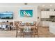Dining room with a stylish table set for a meal, adjacent to the kitchen with modern appliances at 513 Harbor Springs Dr, Palm Harbor, FL 34683