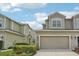 Inviting two-story home with an attached two-car garage and well-maintained front yard at 513 Harbor Springs Dr, Palm Harbor, FL 34683