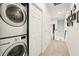 Hallway with washer and dryer, closet, and carpeted floor at 513 Harbor Springs Dr, Palm Harbor, FL 34683