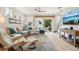 Bright and airy living room featuring stylish decor, comfortable seating and glass sliding doors to the patio at 513 Harbor Springs Dr, Palm Harbor, FL 34683