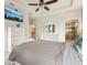 This main bedroom features a ceiling fan, a dresser with mirror, and a large TV at 513 Harbor Springs Dr, Palm Harbor, FL 34683