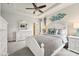 This main bedroom features a ceiling fan, a dresser with mirror and soft decor at 513 Harbor Springs Dr, Palm Harbor, FL 34683