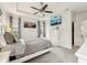 This main bedroom features a ceiling fan, a large TV, and an exterior view at 513 Harbor Springs Dr, Palm Harbor, FL 34683