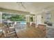 This covered patio includes ceiling fans, a drinking fountain, and a dining table overlooking the pool at 513 Harbor Springs Dr, Palm Harbor, FL 34683