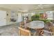 Covered patio features ceiling fans, a drinking fountain, and a table with wooden chairs at 513 Harbor Springs Dr, Palm Harbor, FL 34683