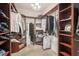 This walk-in closet features dark wood shelving with ample storage at 513 Harbor Springs Dr, Palm Harbor, FL 34683