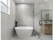 Well-lit bathroom with a freestanding tub, walk-in shower, and modern finishes at 5628 Terrain De Golf Dr, Lutz, FL 33558