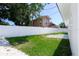 Large, well-maintained backyard features a new white fence, green grass, and trees at 5698 26Th N Ave, St Petersburg, FL 33710